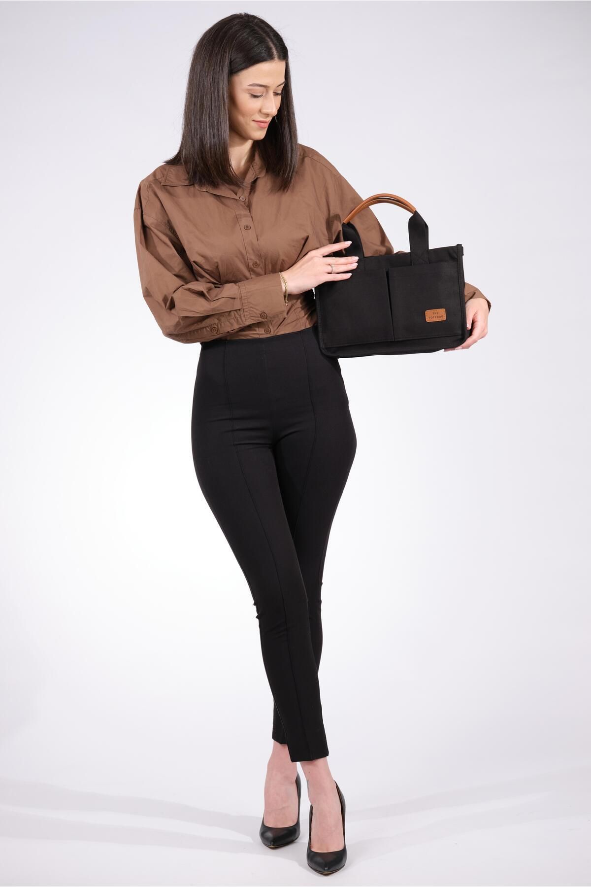 Black purse deals with brown handles