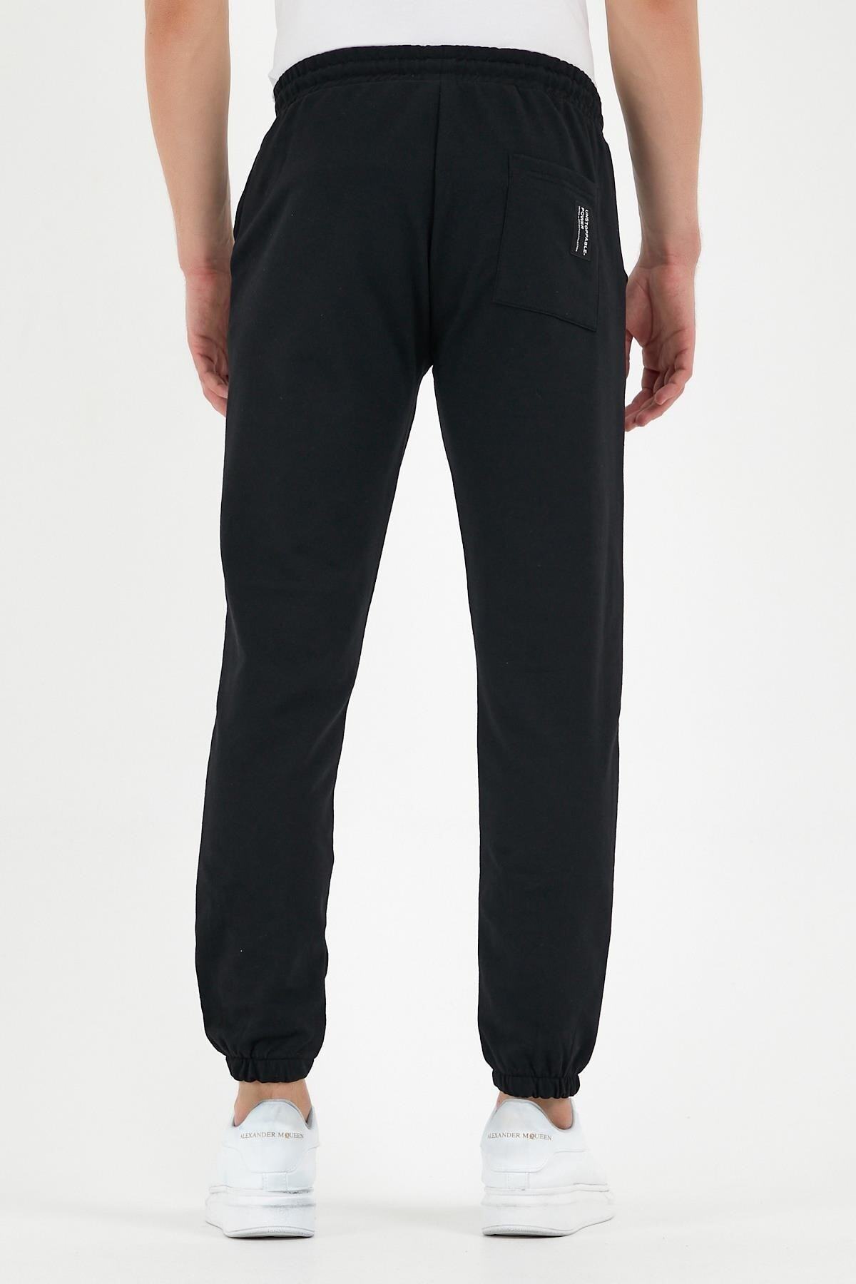 شلوار ورزشی مردانه مشکی با جیب‌های پشت و پهلو، شلوار لاستیکی معمولی