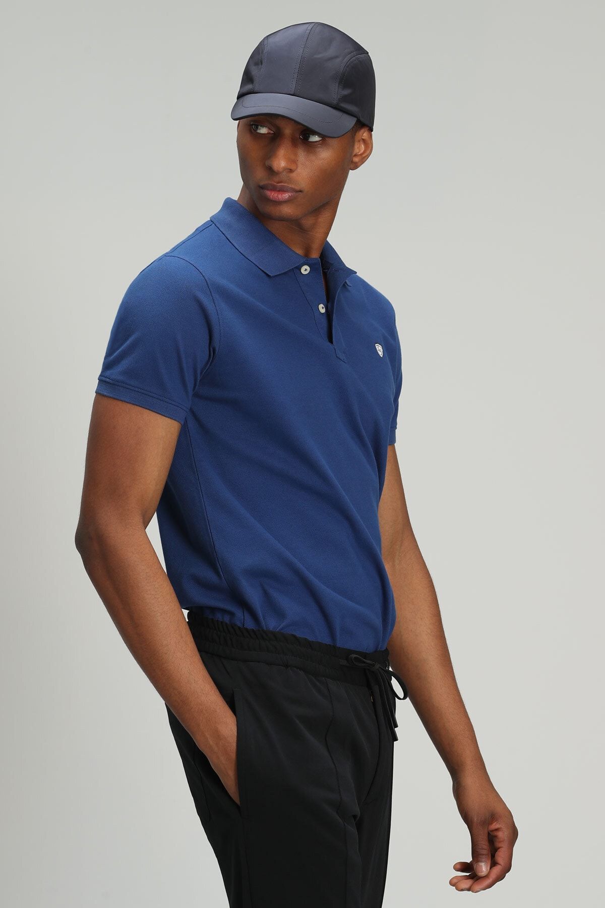 Navy blue polo shop with black pants