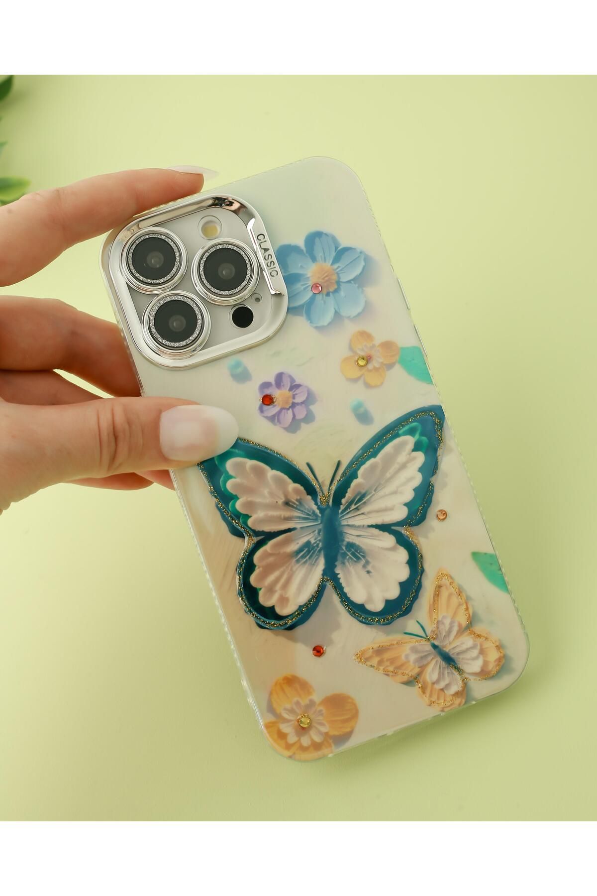 Paladyum Case iPhone 15 Pro Uyumlu Lens Korumalı Simli Kelebekli Çiçekli Kılıf