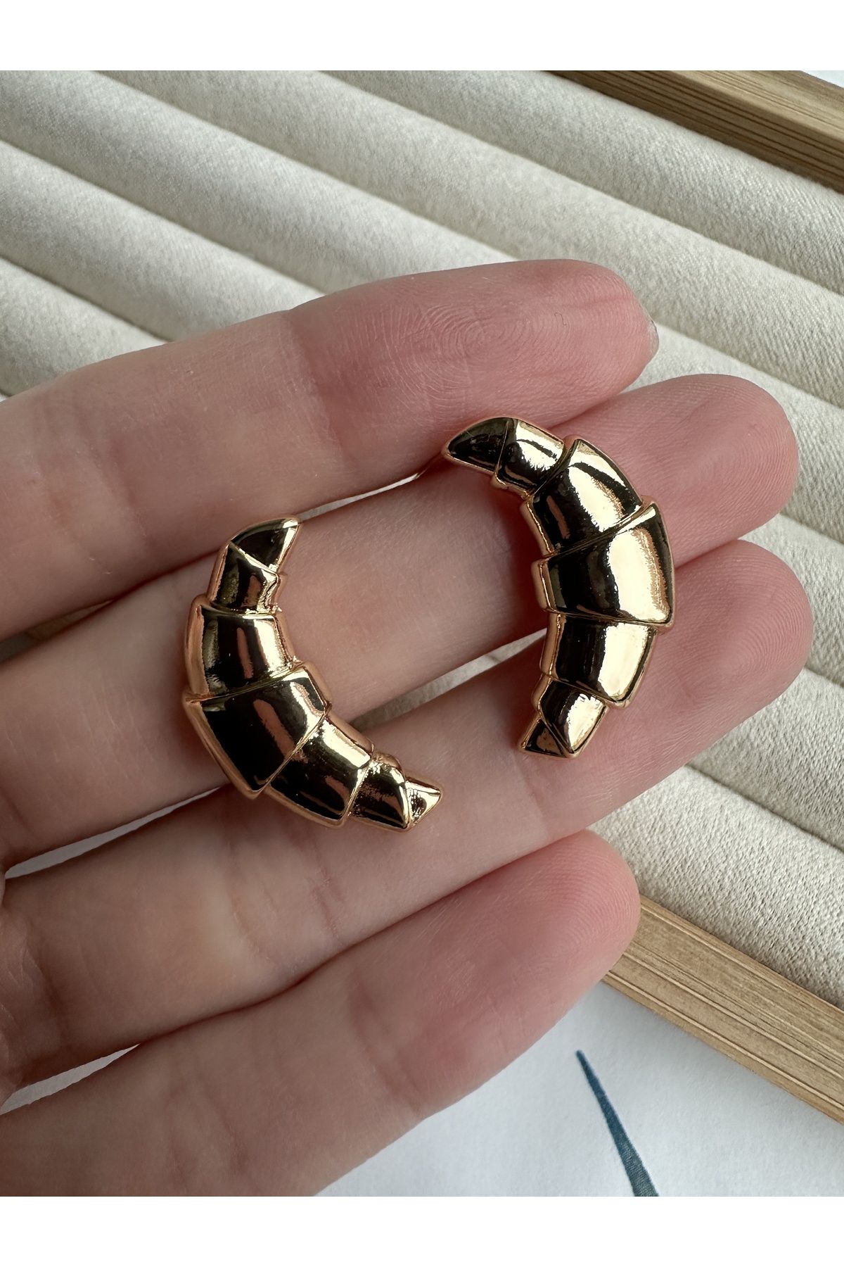 Gold croissant earrings top
