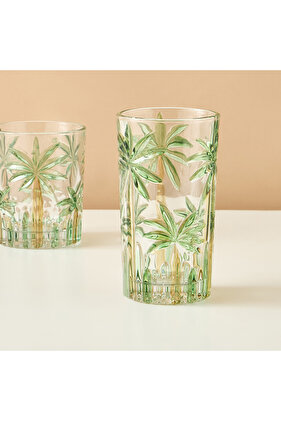 كأس زجاجي طويل منقوش عليه شجرة نخيل