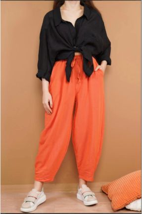 شلوار نارنجی زنانه پارچه ای بافتنی پاچه لوله ای فاق نرمال کد 290614436