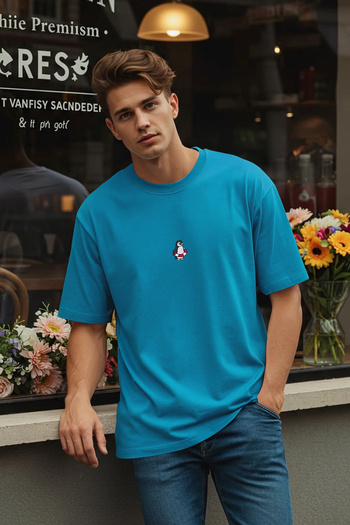 Trendyol Collection Modré oversize vyšívané tričko Penguin ze 100% bavlny TMNSS23TS00243