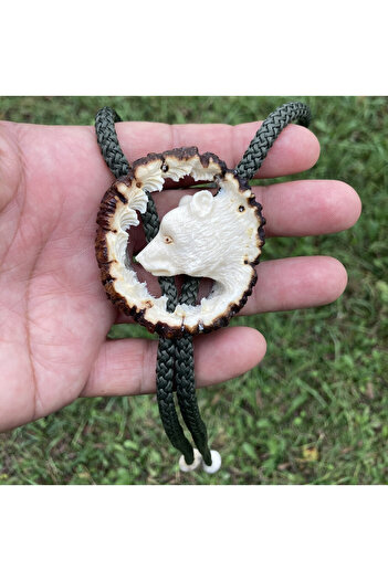 Handmade American bolo tie carved from Carpathian deer horn with bear motif, white