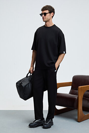 GRIMELANGE Barnaby men's round neck black top and bottom set with sleeve and pant pocket embellishment