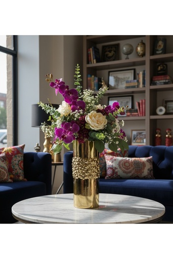 Generic A decorative gold-colored flower vase adds radiance and elegance to your table or room. Comes without the flowers.
