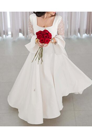 Riva Ivory white wedding dress with long sleeves embellished with sequins.