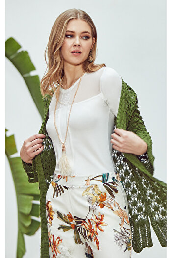 Stylish Elegant home wear in soft fabric, consisting of three pieces, a white top, patterned pants, and a green knitted robe.