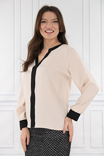 Trend Land Beige blouse with black inserts at the neckline and cuffs