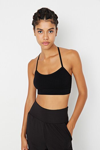 Trendyol Collection Schwarzer nahtloser/nahtloser, leichter, unterstützter/styling-gestrickter Sport-BH mit String-Trägern auf der Rückseite TWOSS22SS0008