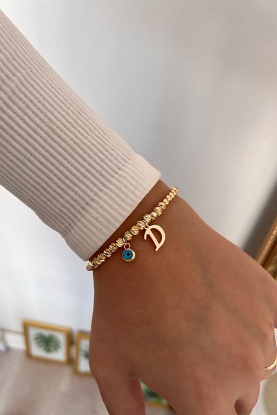 Trendy Butik سوار دوريكا مع حرف D وعين الشر المتدلية