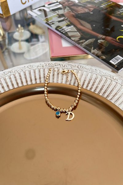 Trendy Butik سوار دوريكا مع حرف D وعين الشر المتدلية