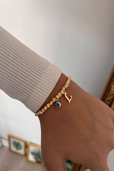 Trendy Butik سوار دوريكا مع حرف L وعين الشر المتدلية