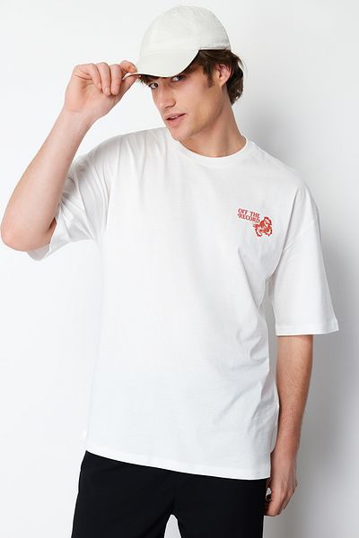 Trendyol Collection Bavlněné tričko s květinovým potiskem Ecru Oversize – krátký rukáv TMNSS24TS00127