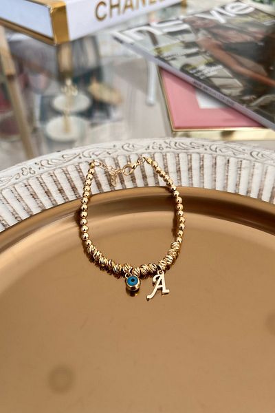 Trendy Butik سوار دوريكا مع حرف A وعين الشر المتدلية