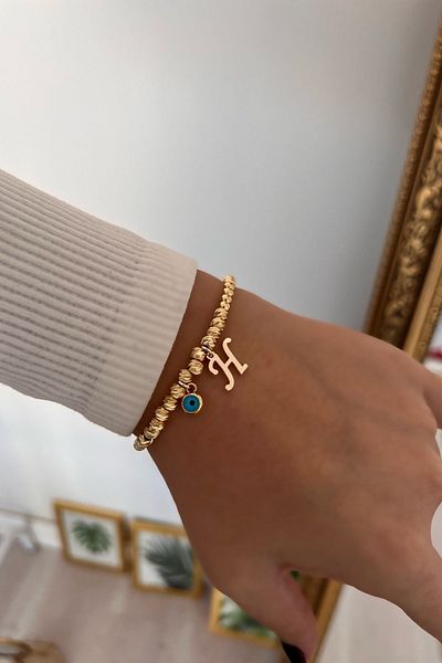 Trendy Butik سوار دوريكا مع حرف H وعين الشر المتدلية