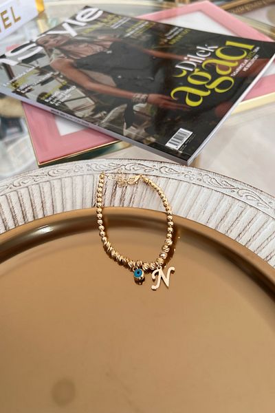 Trendy Butik سوار دوريكا مع حرف N وعين الشر المتدلية