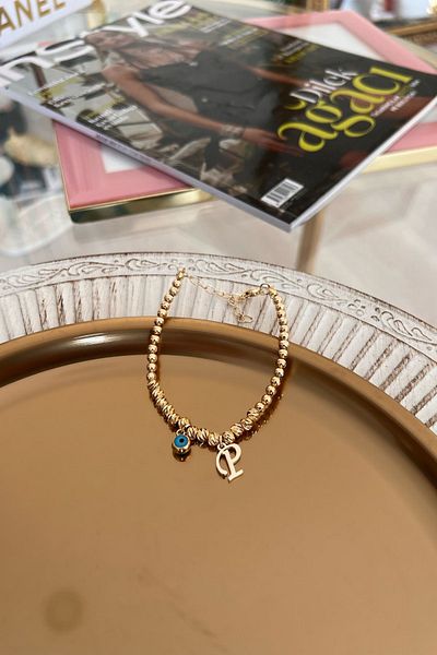 Trendy Butik سوار دوريكا مع حرف P وعين الشر المتدلية