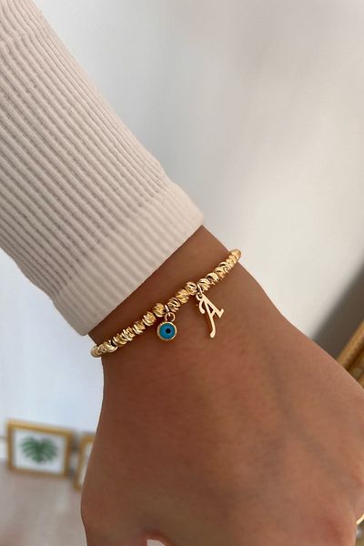 Trendy Butik سوار دوريكا مع حرف A وعين الشر المتدلية