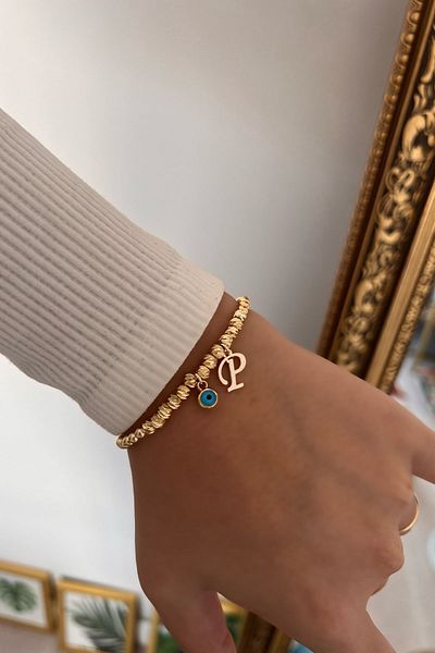 Trendy Butik سوار دوريكا مع حرف P وعين الشر المتدلية