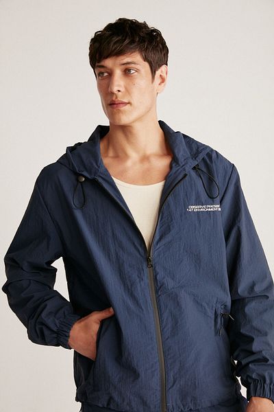 GRIMELANGE Anderson Men's Parachute Fabric, Water Repellent Lined, Pockets and Front Zippered Navy Blue Raincoat