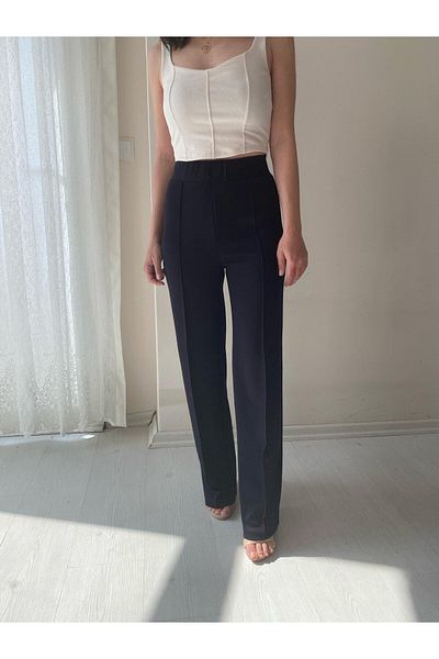Fendimod Pantaloni de damă din țesătură creponată neagră Lycra față de iarbă