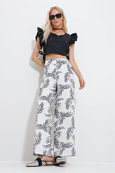 Trend Alaçatı Stili Dámské černé plátěné kalhoty Palazzo s květinovým vzorem ALC-X11861