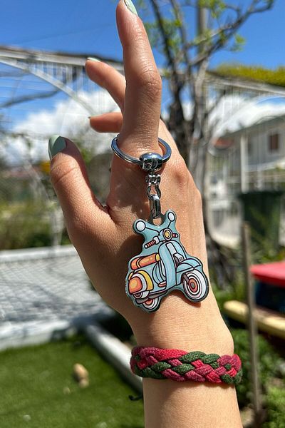 CoNotes Light Blue Keychain with Motorcycle Design