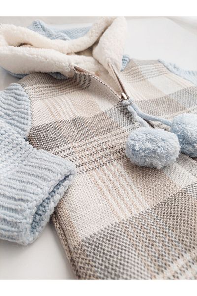 a baby Merino Lined Lamb Pompom Jumpsuit
