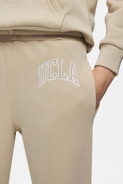 UCLA بنطال رياضي نسائي من Jules باللون البيج الداكن ومطرز بأرجل غير رسمية