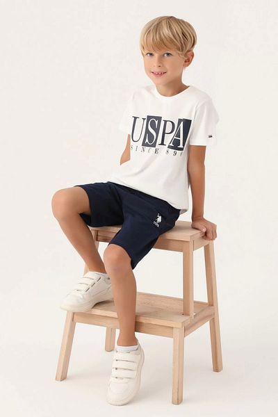 U.S. Polo Assn. بدلة برمودا للأولاد باللون الكريمي المرخص من US Polo Assn