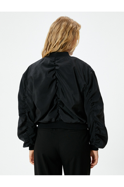 Koton Bunda padákového bombardéru s detailem kapsy na zip