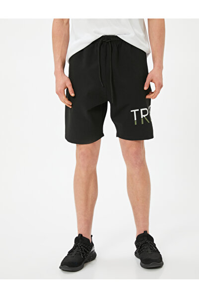 Koton Sportovní šortky oversize s potiskem sloganu, šněrováním v pase, kapsami a ocelovou výztuží z interloku