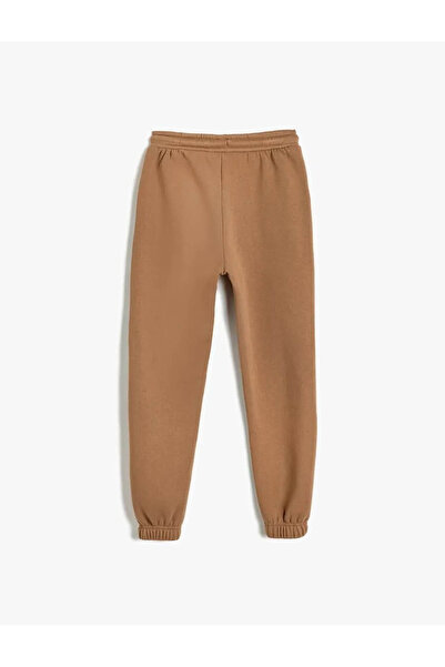 Koton Chlapecké tepláky s vázáním v pase a kapsou s detaily v hnědé barvě 5WKB40030TK