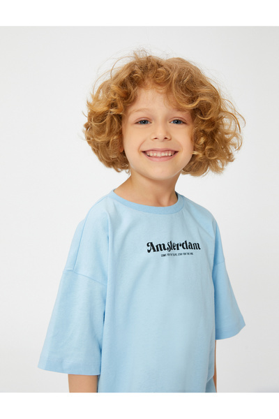 Koton تي شيرت كبير الحجم مطبوع عليه أمستردام وأكمام قصيرة ورقبة دائرية من القطن