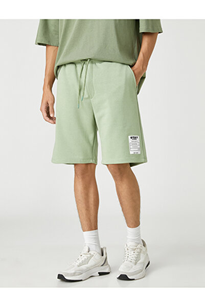 Koton Základní šortky s krajkovým pasem s potištěnými kapsami s logem štítku