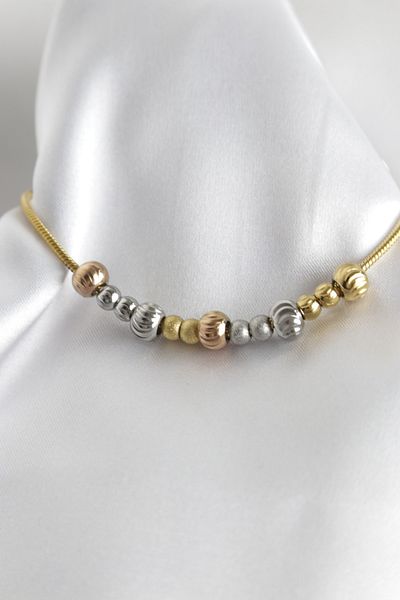 Store سوار من الفولاذ الذهبي مزين بالخرز
