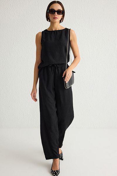 Trendyol Collection Schwarze ärmellose Bluse und elastische Taille, weites Bein/Hose mit weitem Bein, gewebtes Oberteil, TWOSS25AU00029