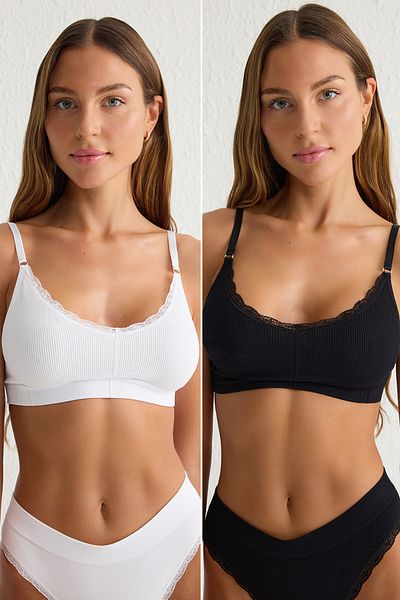 Trendyol Collection Schwarz-weißer 2-teiliger, nahtloser Bralette-Strick-BH ohne Bügel mit Spitzendetail THMSS25SU00018