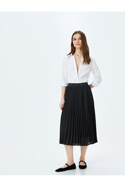 Koton Medium rise midi length pleated skirt.