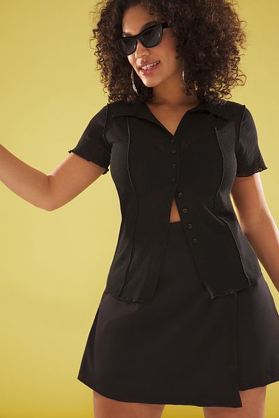 Trendyol Curve Schwarze, durchsichtige, körperbetonte, dehnbare Strickbluse mit Hemdkragen in Übergröße TBBSS25AF00061