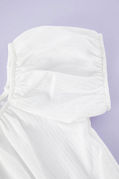 TRENDYOLKIDS Ecrufarbene, dehnbare Strickbluse mit Ballonärmeln für Mädchen TKDSS25BZ00003