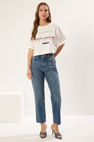 Trendyol Collection Ecrufarbenes Strick-T-Shirt aus 100 % Baumwolle mit entspannter/bequemer Passform und hohem Slogan-Print TWOSS25TS00079
