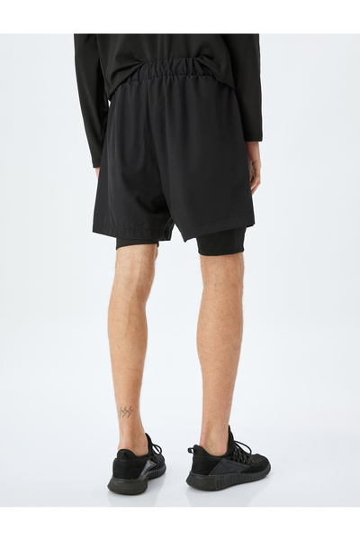 Koton Parachute fabric pocket detail drawstring sport shorts with leggings.