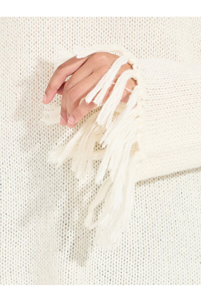 Styli Knitted Turtle Neck Sweater with Tassel Hem Detail