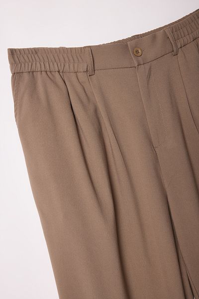 Trendyol Collection Beigefarbene, lockere Wideleg-Stoffhose in Übergröße TMNAW25AR00000