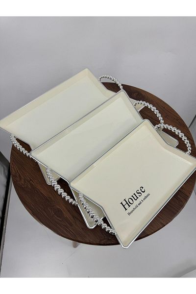 Living A set of two-piece oval serving trays with a sophisticated wavy design, sugar/silver