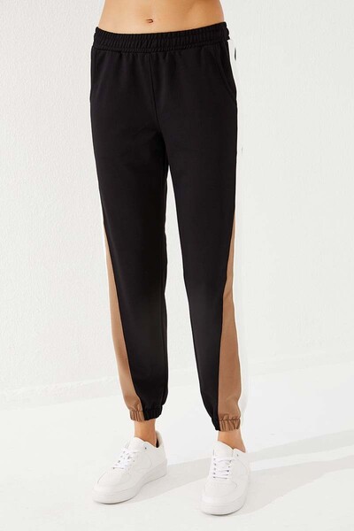 TOMMY LIFE Dámské tepláky černé dvoubarevné pruhované pohodlné tvary s gumou - 94582