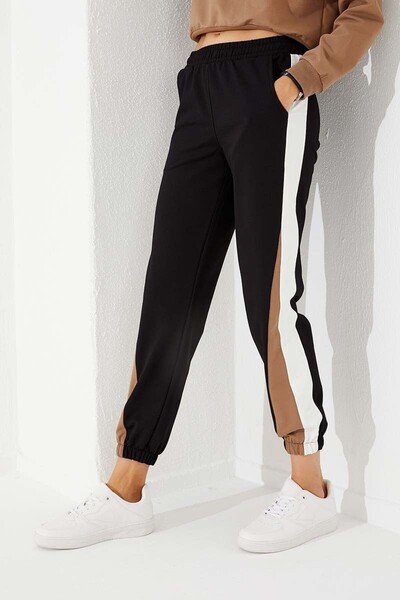 TOMMY LIFE Dámské tepláky černé dvoubarevné pruhované pohodlné tvary s gumou - 94582